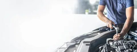 Специалист выполняет работы с автомобильным двигателем